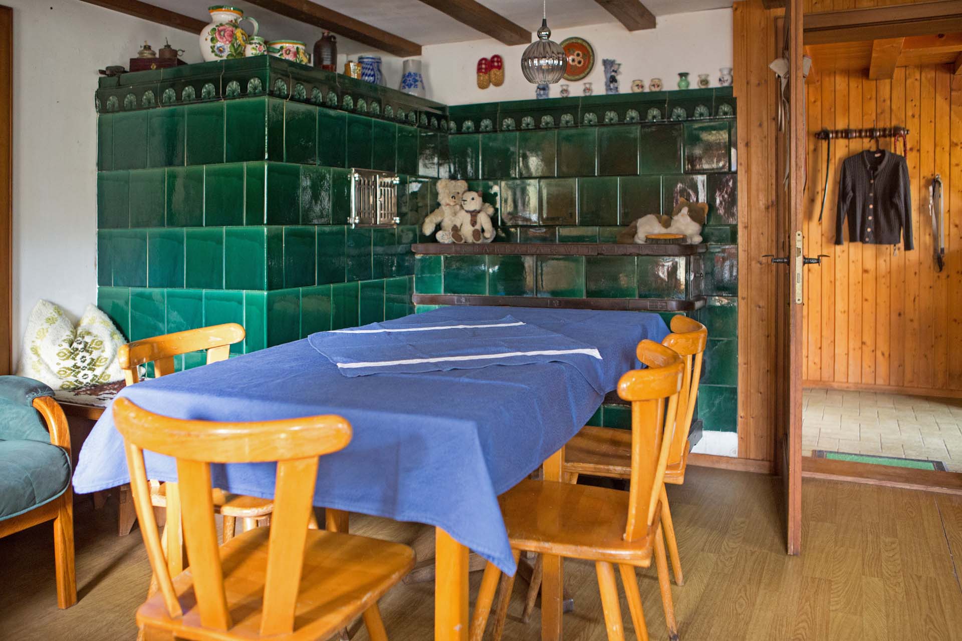 The dark green ceramic oven, people here called it "Kunst", in the Dobelhof farmhouse provided warmth for the boys. Beside the kitchen, this room was the only heated room in the house.
