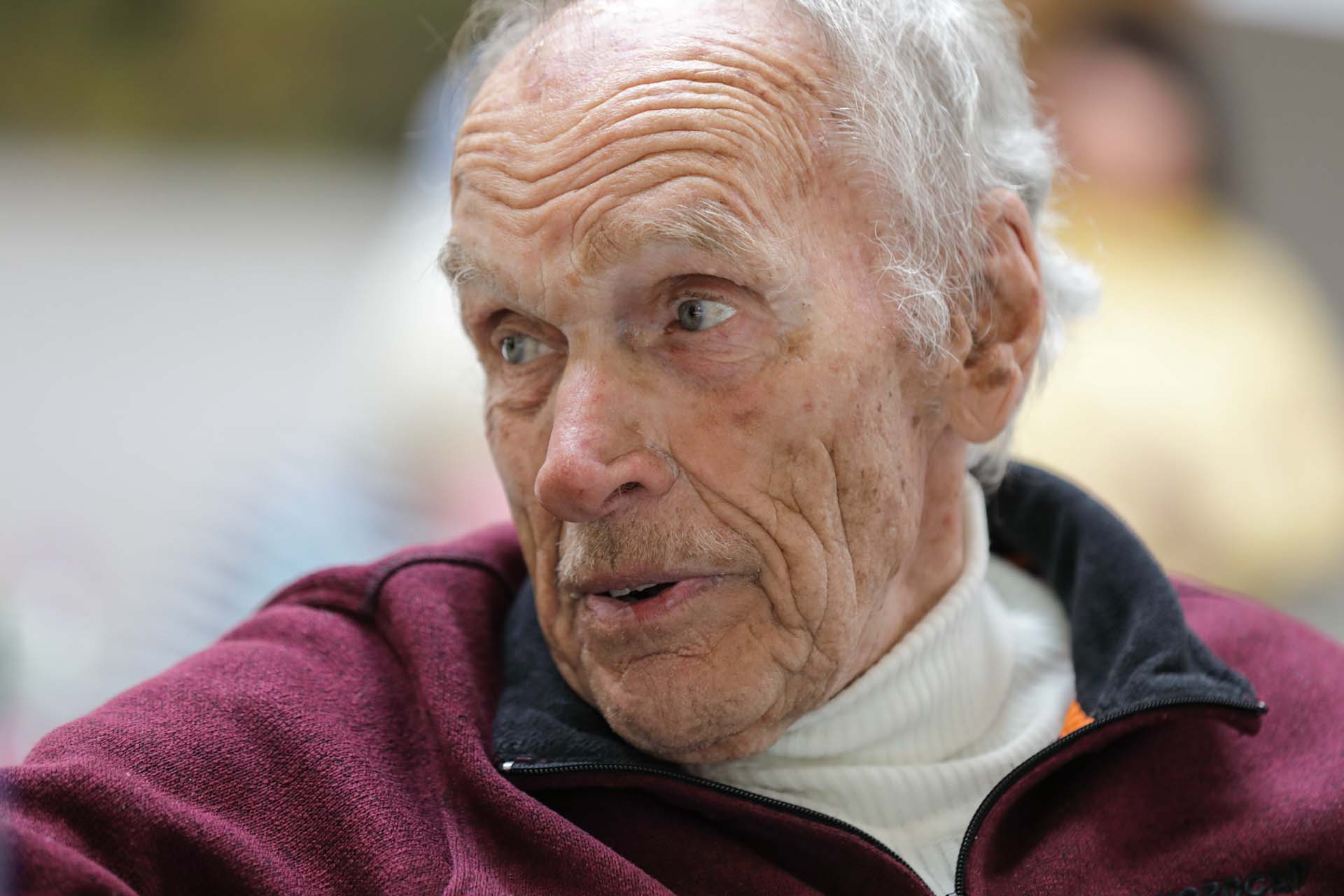 Kurt Lorenz, whose father, Bruno, the village cobbler, was involved in the rescue effort, listening to speeches at the Hofsgrund community centre.